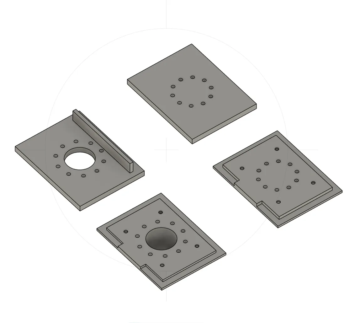 CAD render of four further plates carrying the same ring of vent holes, one with a raised rectangular bar beside the opening and two rebated so an inner platform stands proud of the outer edge.