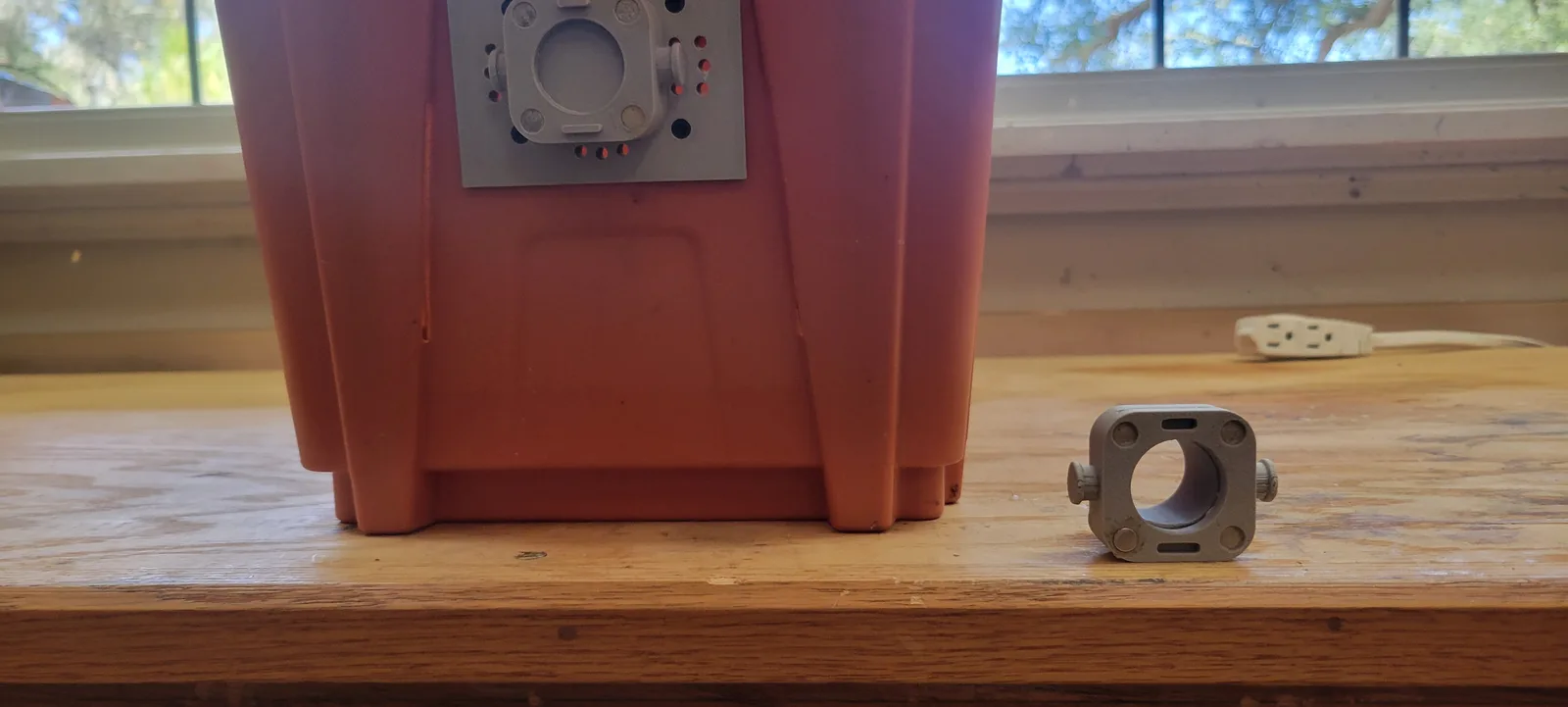 The tunnel adapter on the box with the side latch clip sitting loose beside it.